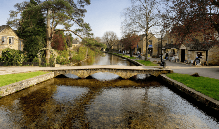 A low, three-arched bridge crosses the river in Bourton-on-the-Water.