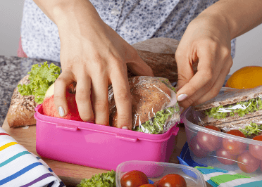 A runner packs her lunchbox with a balanced lunchtime meal.