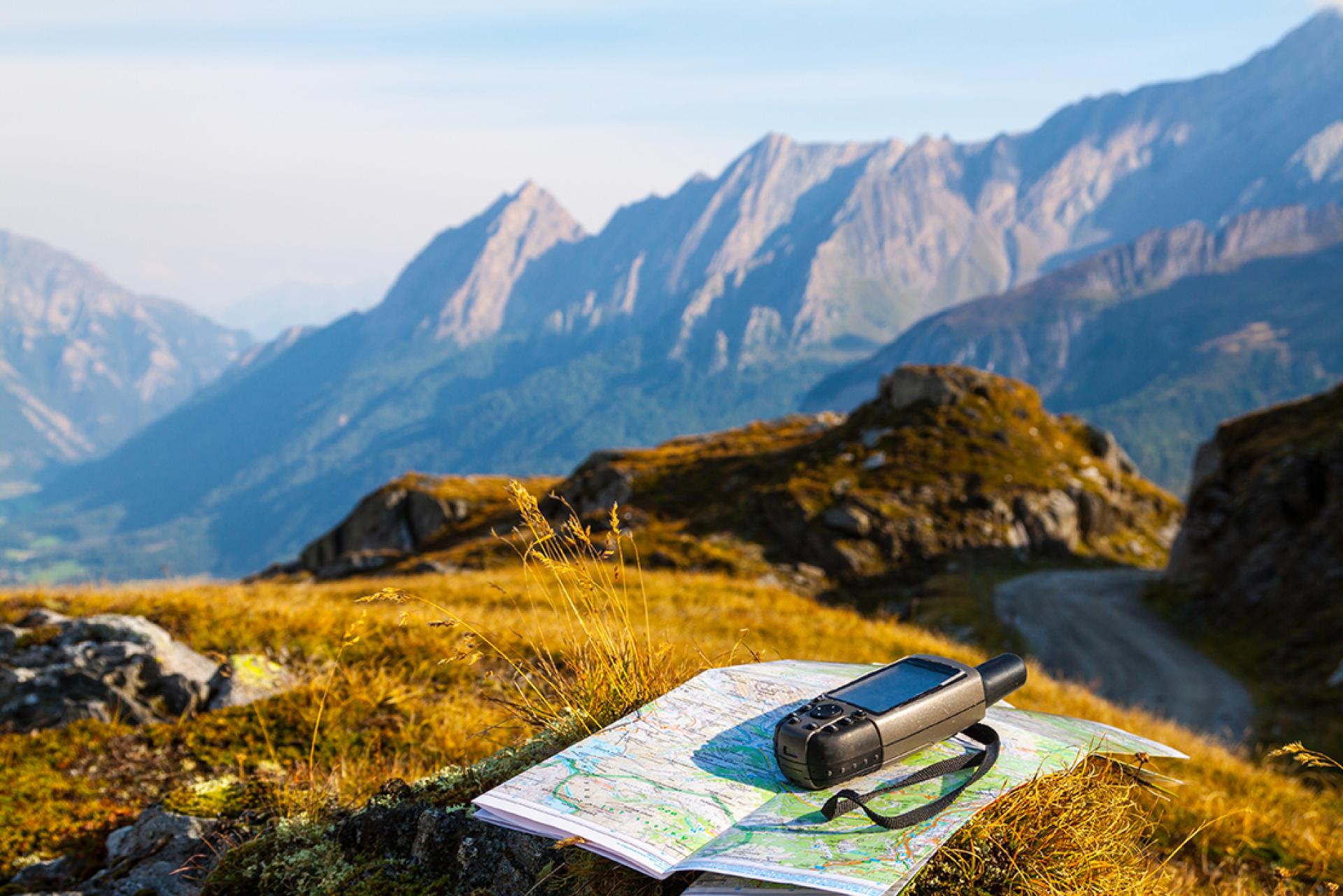 GPS and map on a grassy outcrop