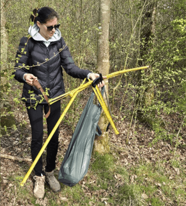 A Contours team member tries to gather up a yellow metal tape measure found in the bushes at Carsington.