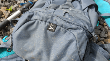 A sewn-in label marks the site of an integral tool roll on this Osprey Raven 14 rucksack.